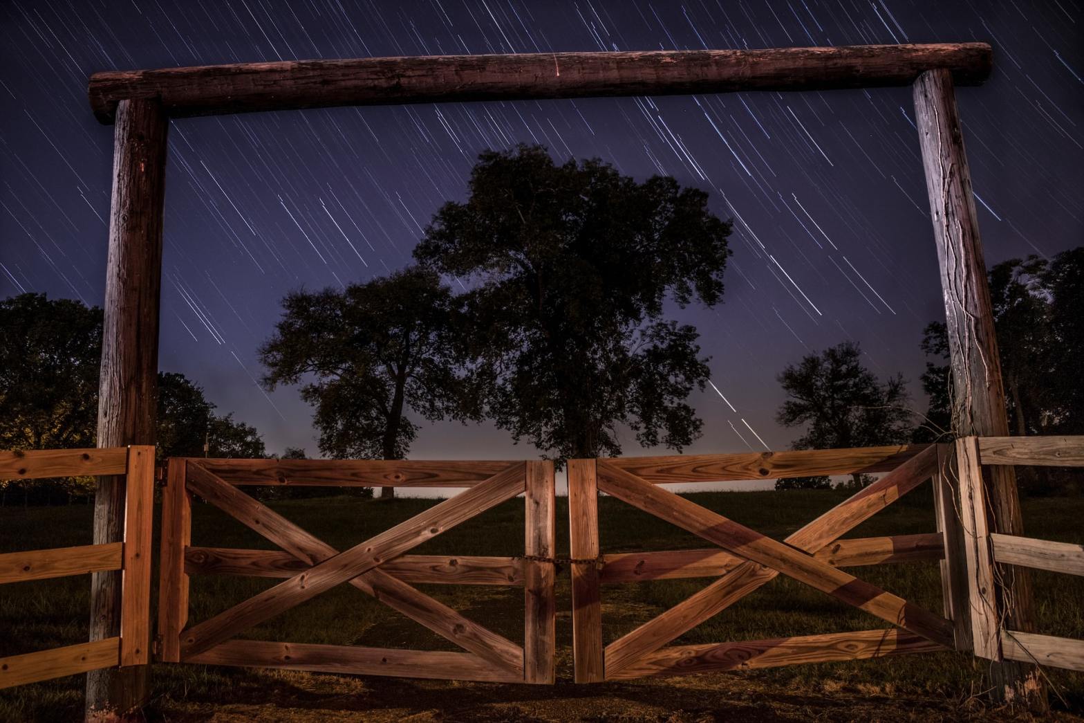 gate with stars streaking overhead